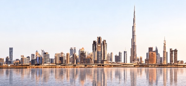 Dubai skyline with the Burj Khalifa reflected in the water.